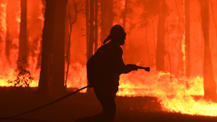 A silhouette of a firefighter surrounded by flames