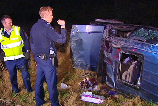Police inspect the damage after a woman allegedly crashed with ten children on board in August last year.