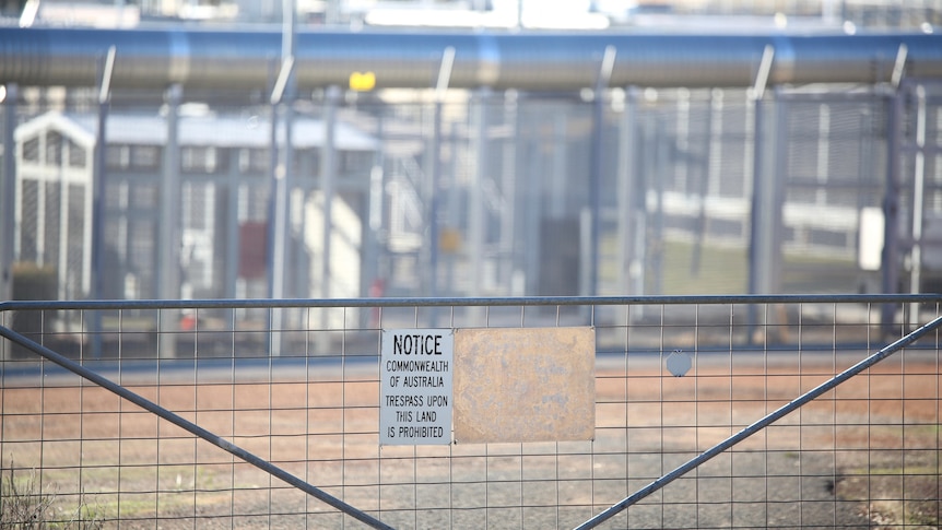 A gate with a warning sign on it outside Yongah Hill immigration detention centre.
