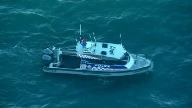 A police boat joins the search for a missing child at Pearl Beach on the NSW central coast.