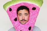 Phil Ferguson wearing a crocheted watermelon hat.