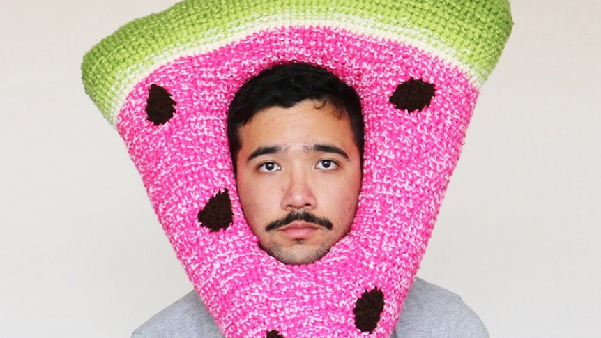 Phil Ferguson wearing a crocheted watermelon hat.