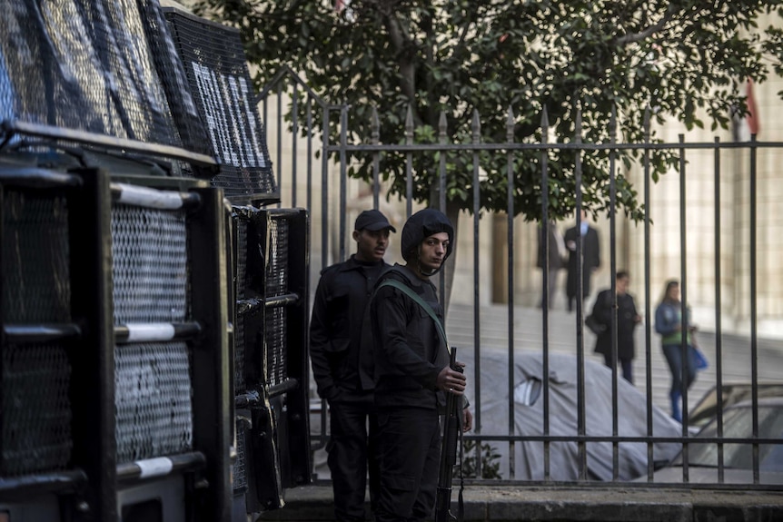 Egyptian riot policemen stand guard outside the High Court in downtown Cairo on January 1, 2015