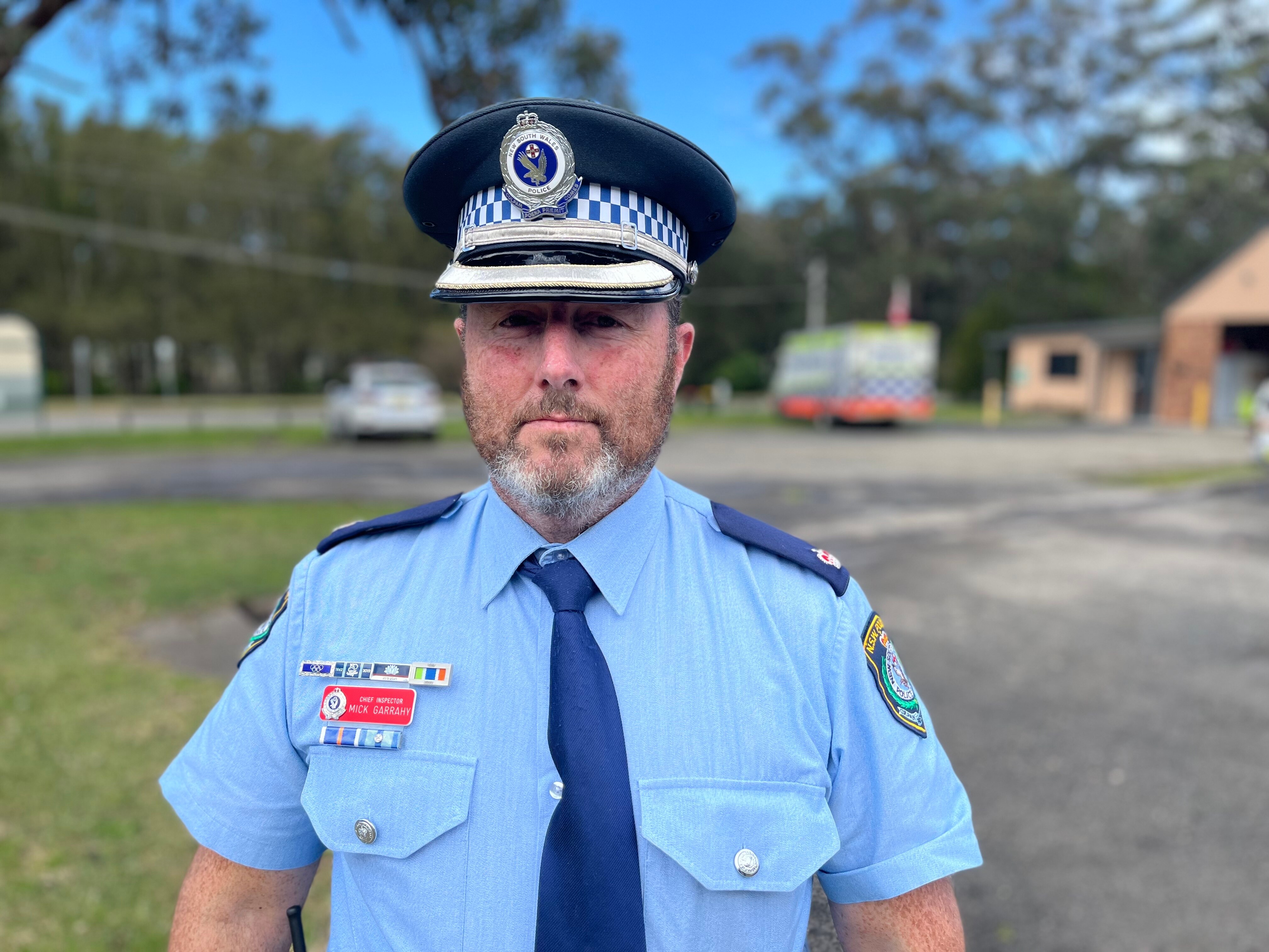 a police man looks into the camera