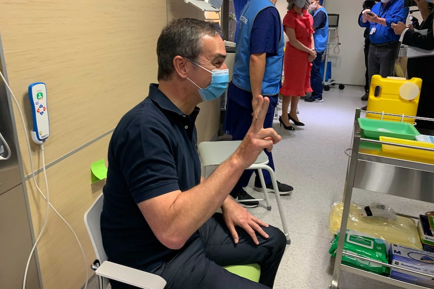 SA Premier Steven Marshall sitting in a seat wearing a blue face mask