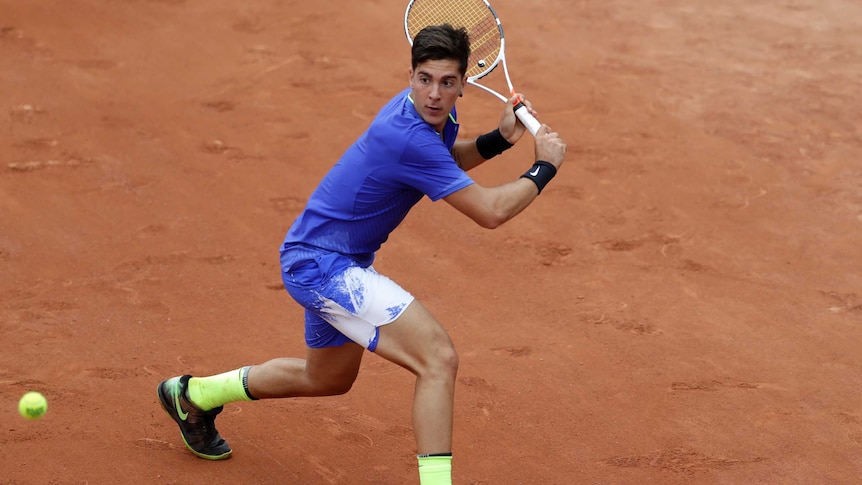 Thanasi Kokkinakis plays a backhand return against Kei Nishikori at the French Open