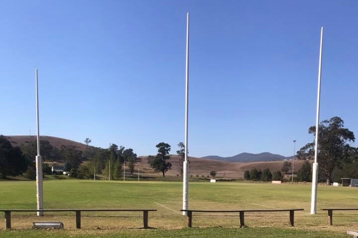 A football oval is seen with hills in the background