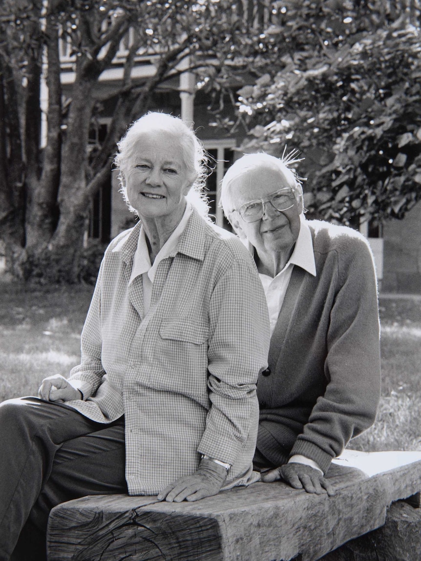A black and white photo of an elderly man and woman in a garden