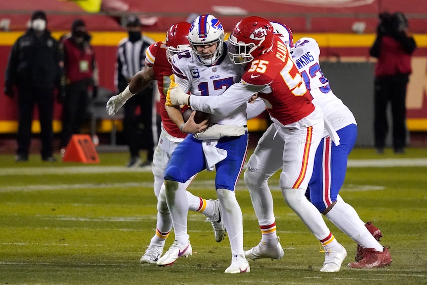 Josh Allen is tackled by a player wearing red