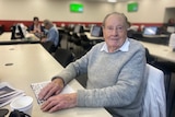 Aldo, in his late-80s, sitting at a bingo hall in Melbourne