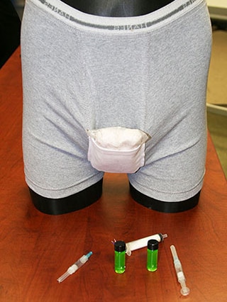 A mannequin wears a pair of men's underwear with an unidentified pack concealed.