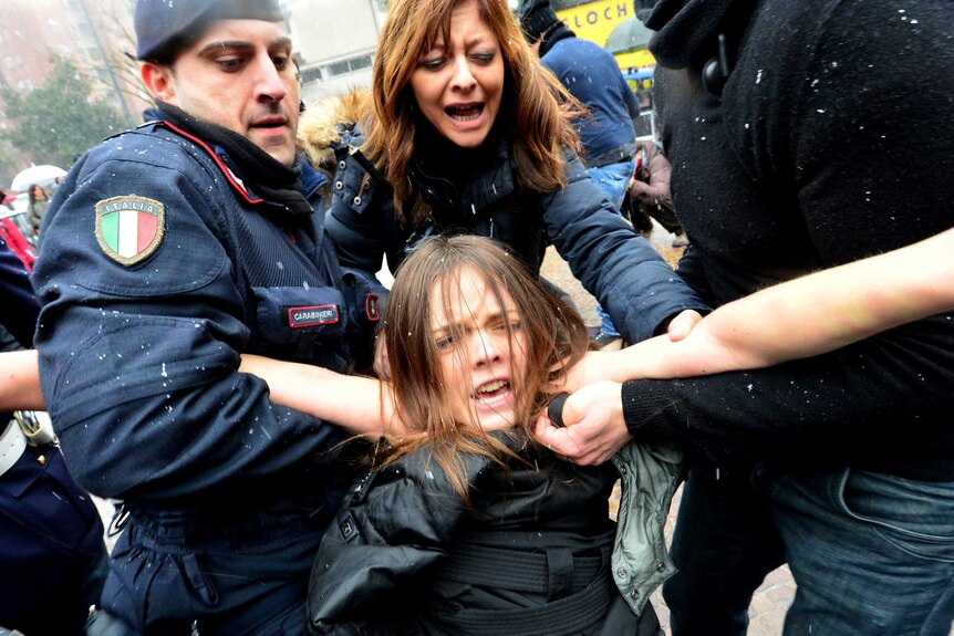 Topless feminist arrested after trying to confront Silvio Berlusconi