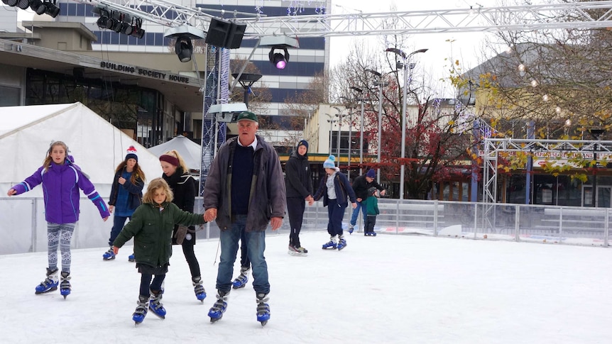 Families take to the ice-skating rink.