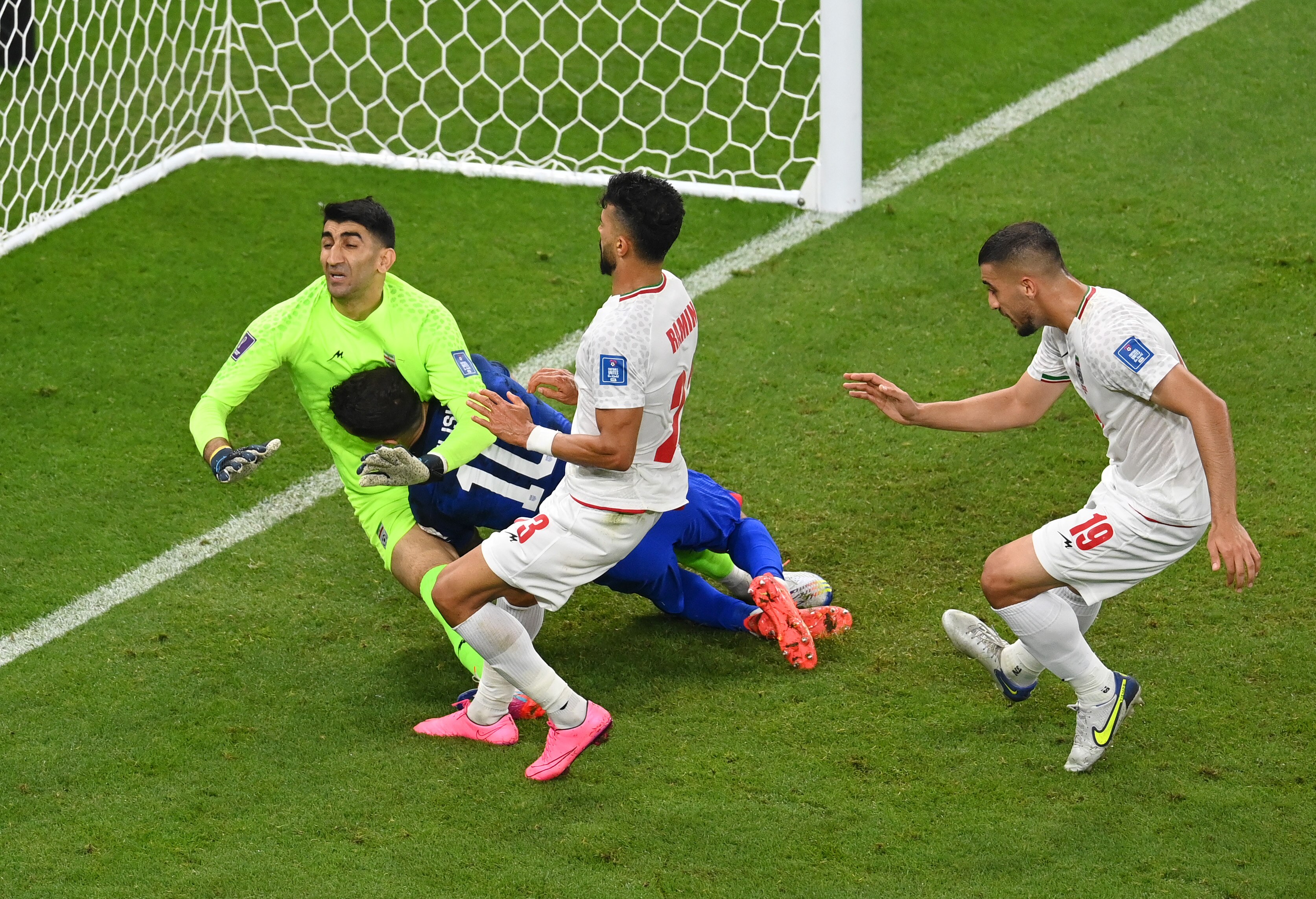 Christian Pulisic slams face first into Iran's goalkeeper near the goal line