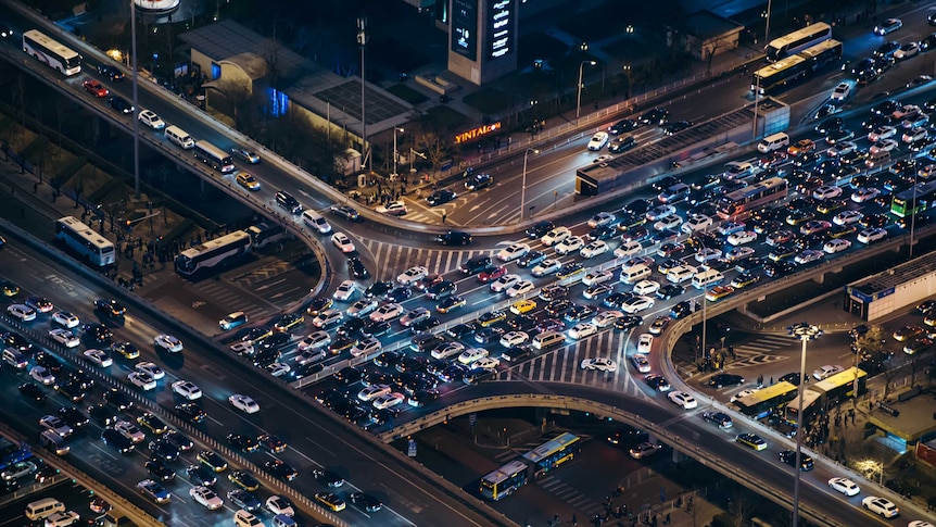 Hi angle shot of traffic jam on a freeway at night time.