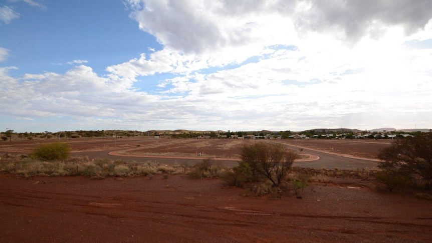 Red dirt and a road in the empty and undeveloped site of the Newman Estate