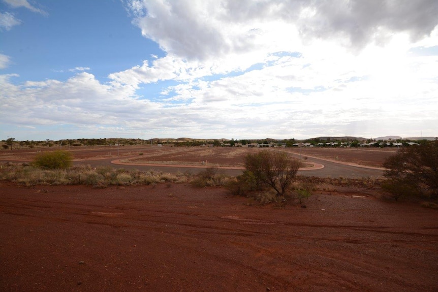 Red dirt and a road in the empty and undeveloped site of the Newman Estate
