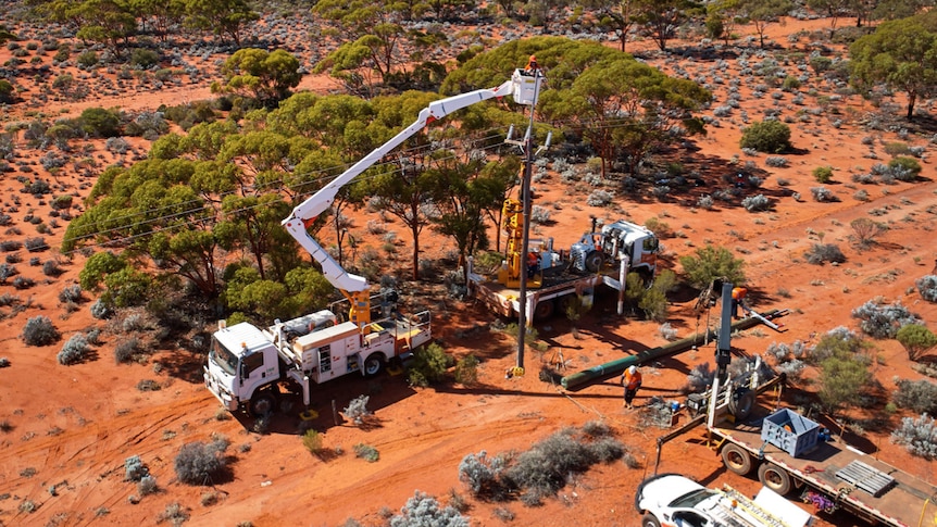 Machinery being used to replace a power pole in the bush.