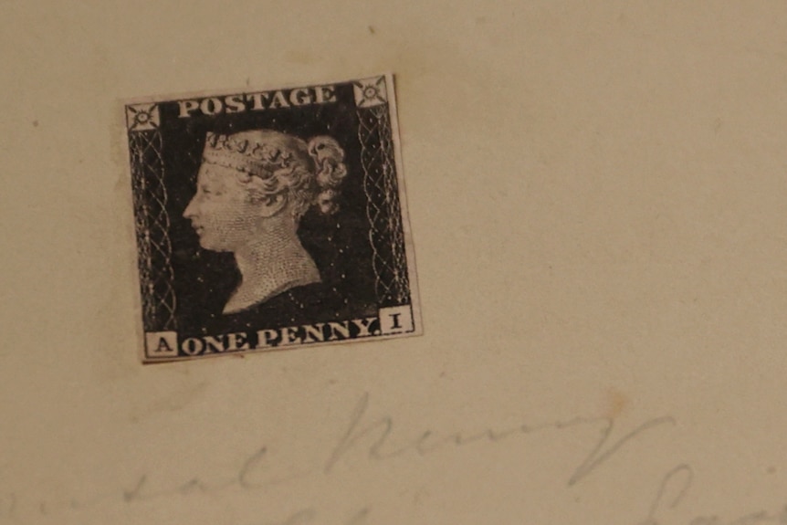 Postage stamp glued to a sheet of paper.