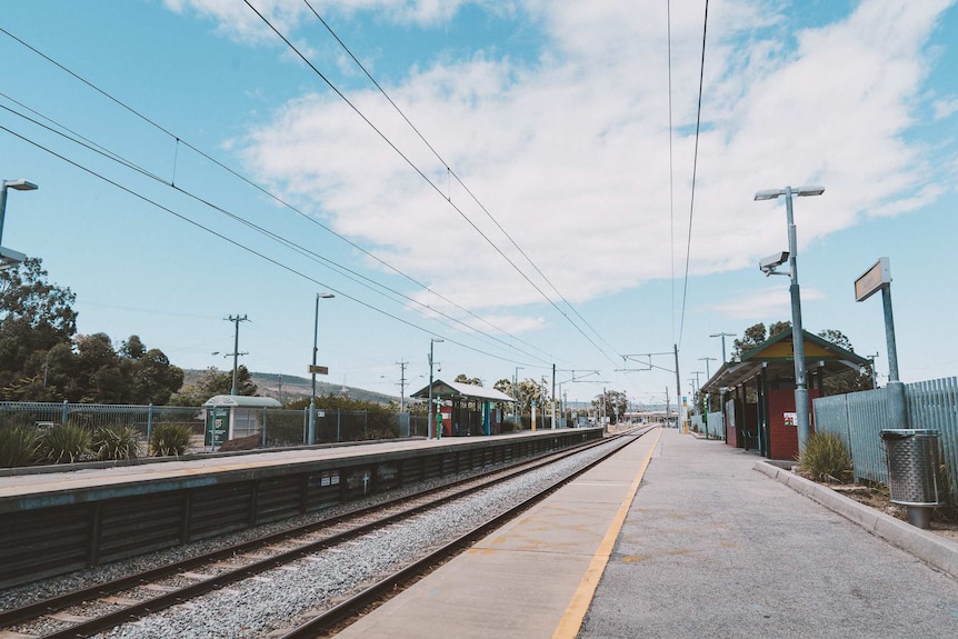 A wide shot of a vacant Seaforth train station under a blue sky in Gosnells.