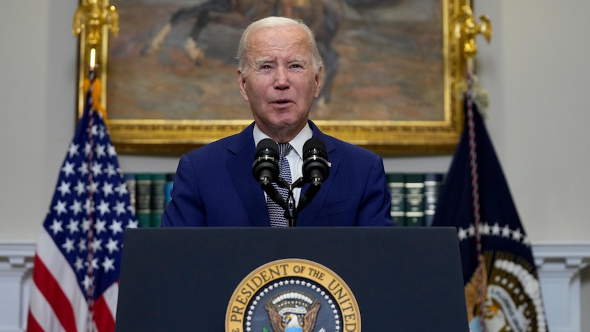 Joe Biden stands in front of presidential podium 