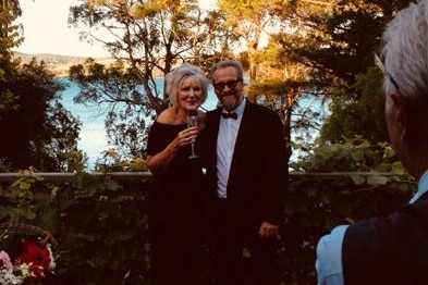 Clare and Nigel Lazenby standing on their deck three years ago