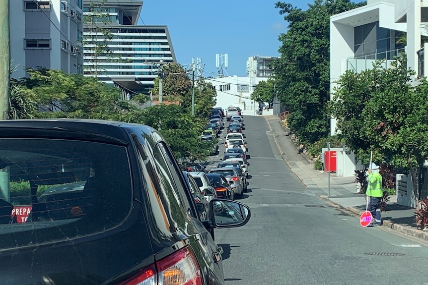 Cars line up on a road in the suburb of Bowen Hills.