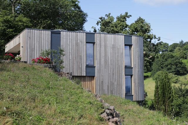 A timber-clad hillside home in Malvern, Worcestershire.