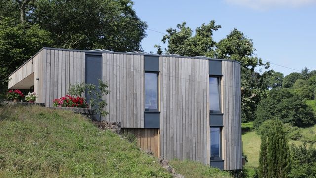 A timber-clad hillside home in Malvern, Worcestershire.