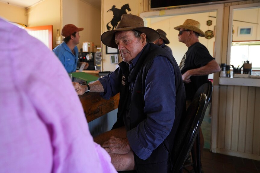 Man wearing an akubra drinking at the bar 