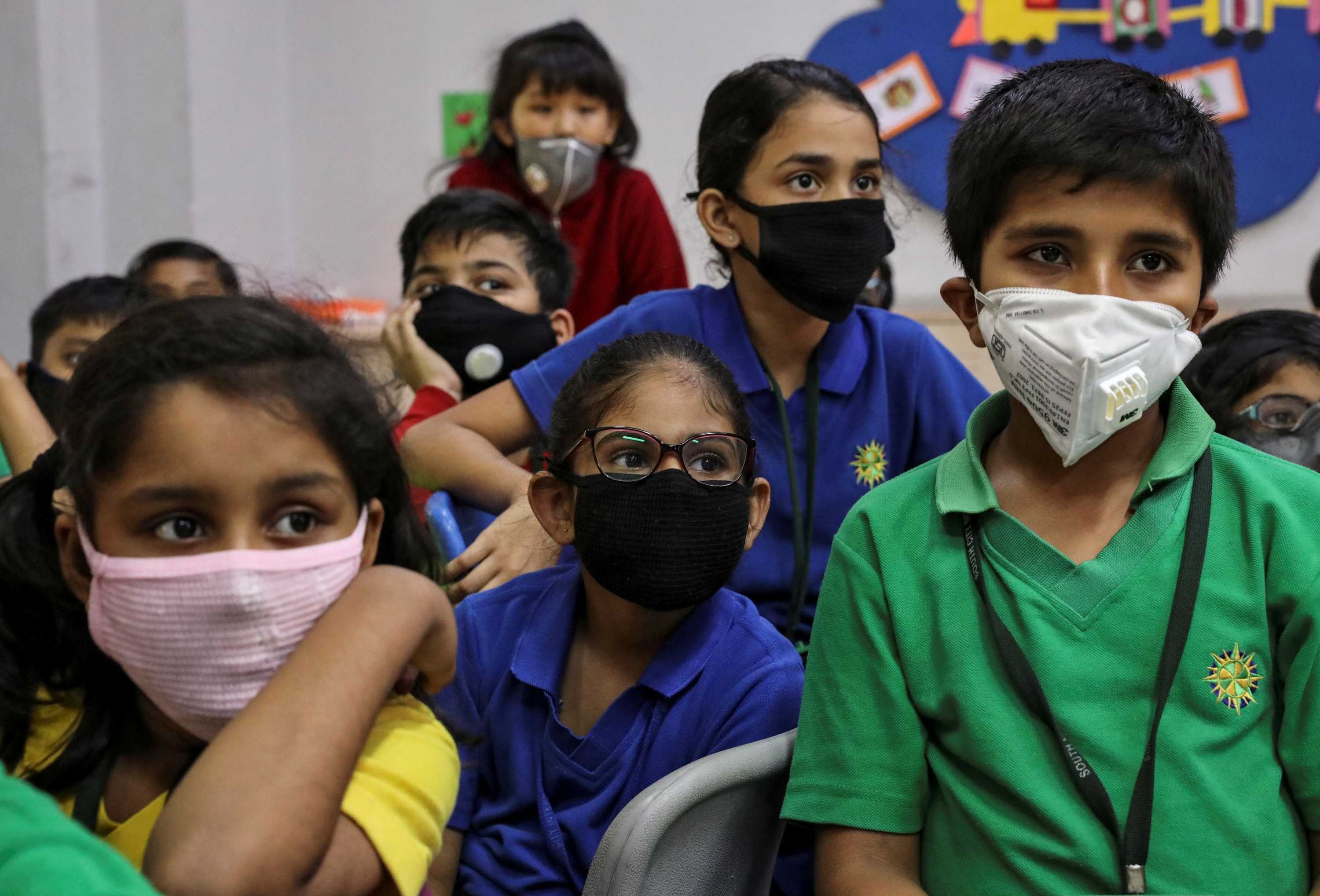 Young kids in India wearing face masks in a classroom