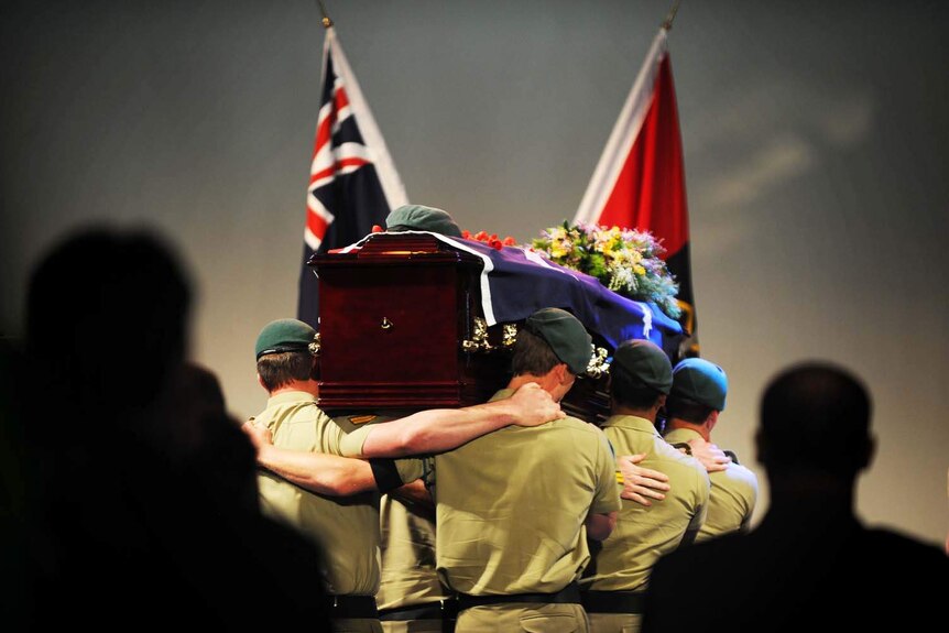 Soldiers from the 2nd Commando Regiment carry Corporal Baird's coffin at his funeral service on the Gold Coast.