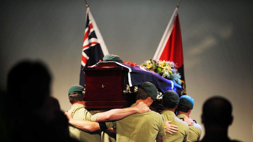 Soldiers from the 2nd Commando Regiment carry Corporal Baird's coffin at his funeral service on the Gold Coast.