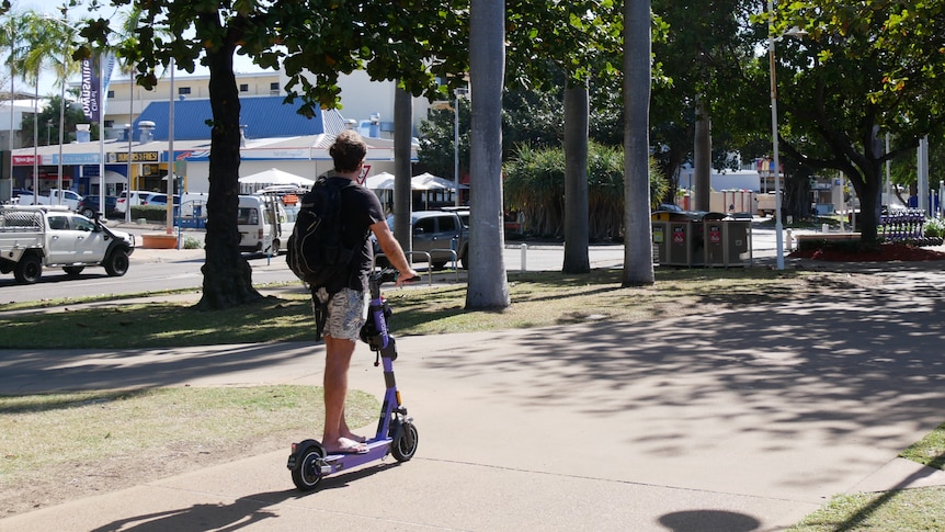 Man rides e-scooter down Townsville street