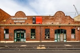 The brick exterior of Threshermans Bakehouse with a for lease sign.