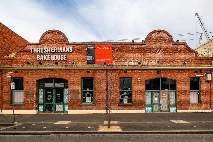 The brick exterior of Threshermans Bakehouse with a for lease sign.