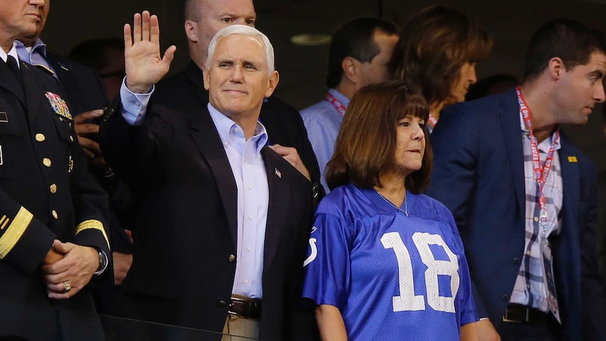Vice President Mike Pence waves to fans before an NFL football game.