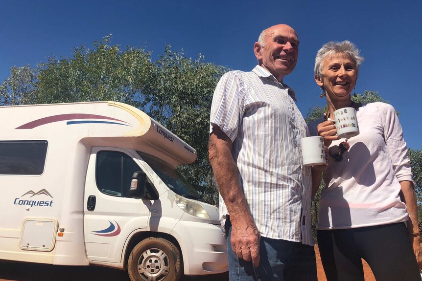 Peter and Barbara Alcock stand with their camper van at the Nillibubbica rest stop in the Kimberley.