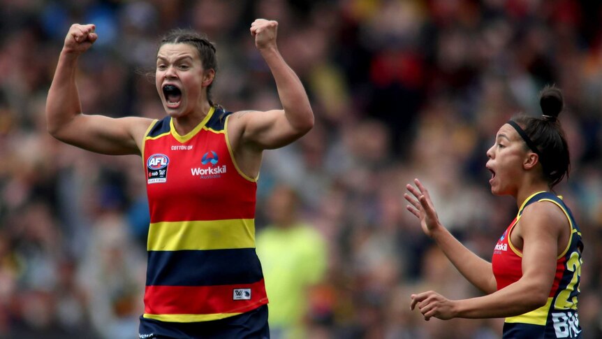 Anne Hatchard clenches both fists as her teammates celebrate the Adelaide Crows' first goal in the AFLW grand final.