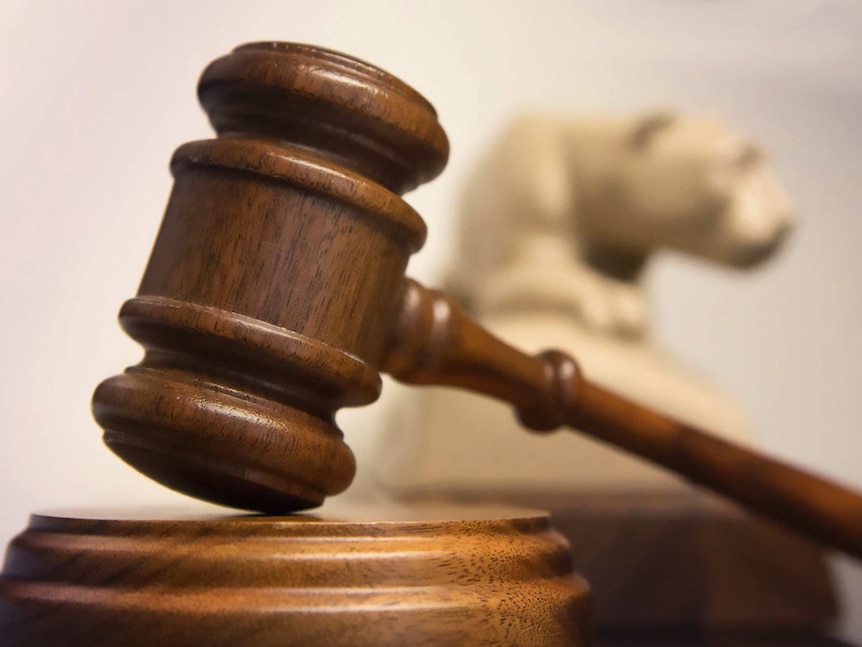 A close-up shot of a gavel on a bench.