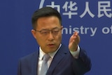 A Chinese foreign ministry spokesman gestures