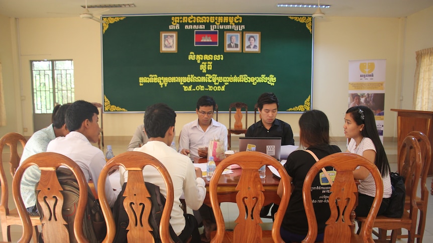 Young Cambodians sitting around a table having a meeting