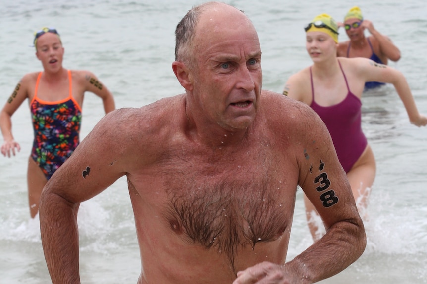 A man leaves the ocean after a swim