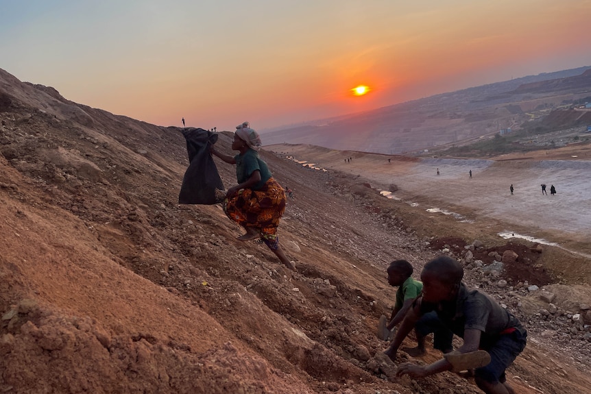 A woman scales a mine.