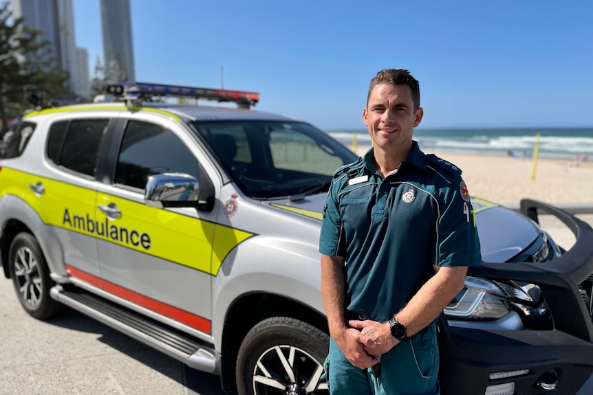 paramedic man standing in front of an ambulance