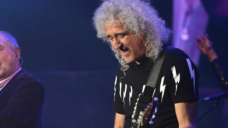 Queen's Brian May performs on stage.