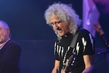 Queen's Brian May performs on stage.
