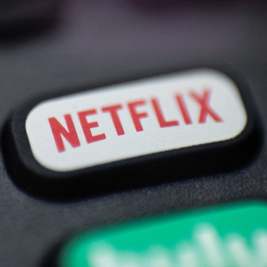 Photo shows a logo for Netflix on a remote control