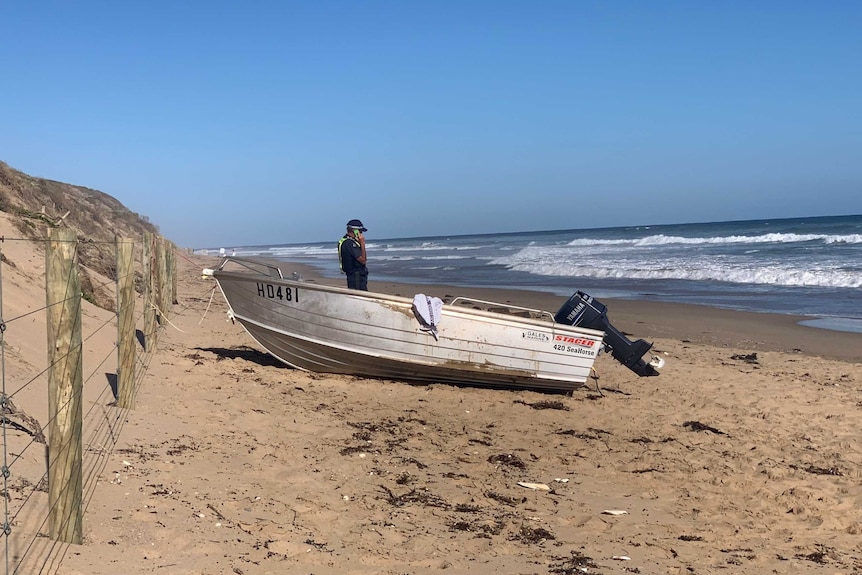 Police on the beach at Anglesea after one person died being swept into the water from a boat. January 2021.