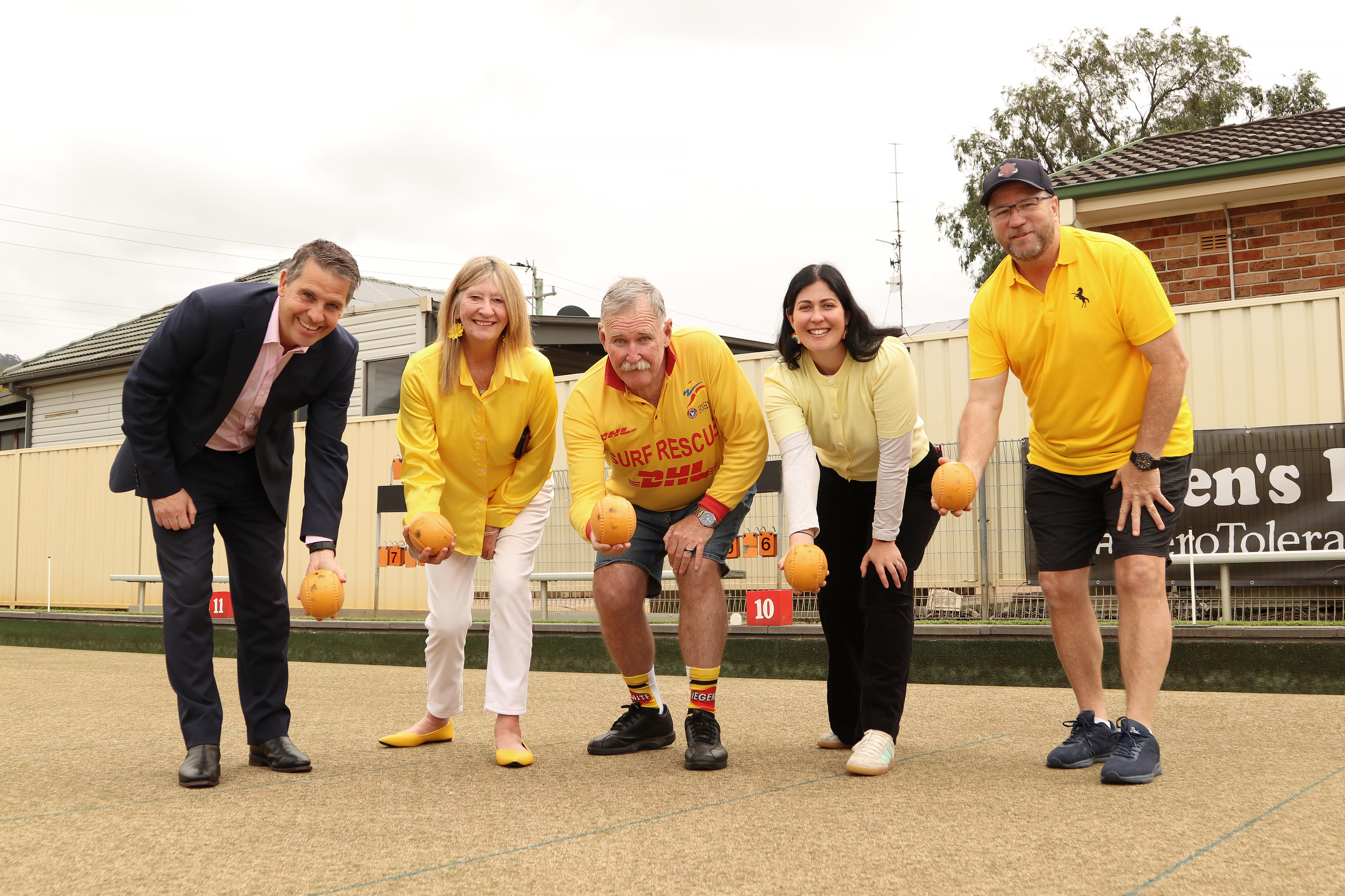 Five people bending over pretending to bowl.